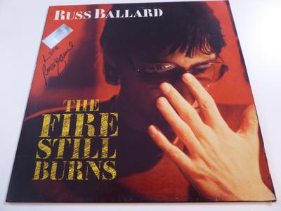 Tumnagel för auktion "RUSS BALLARD / ARGENT - SIGNERAD LP AUTOGRAF - "THE FIRE STILL BURNS" - 1985!!!"