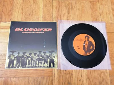 Tumnagel för auktion "Gluecifer – Mano-A-Mano, 7" (Safety Pin Records, 1998)"