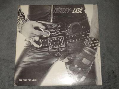 Tumnagel för auktion "Mötley Crüe -too fast for love- leathür records första press"