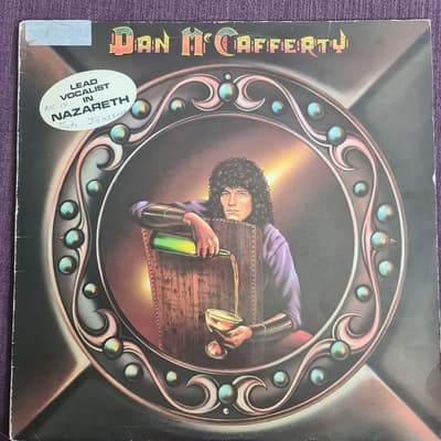 Tumnagel för auktion "Dan Mc Cafferty, Vinyl LP"