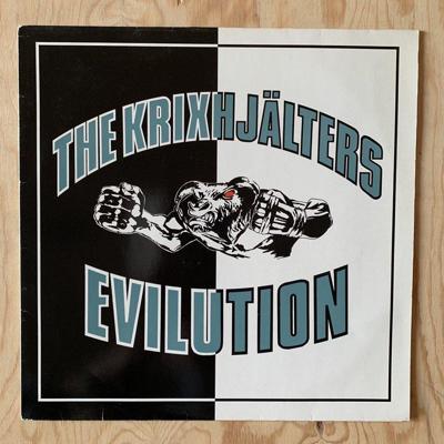 Tumnagel för auktion "THE KRIXHJÄLTERS • EVILUTION • EX • MYCKET FINT SKICK • 1989 • ORIGINAL LP"